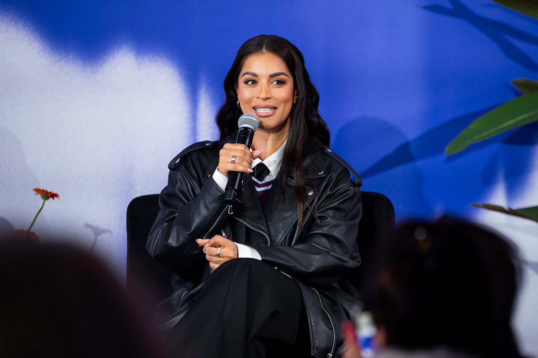 A speaker in conversation on stage at Departure Festival + Conference