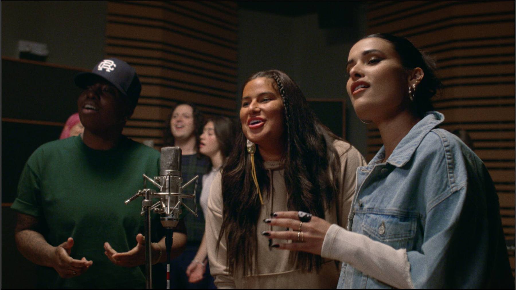 Artists singing together in a recording studio