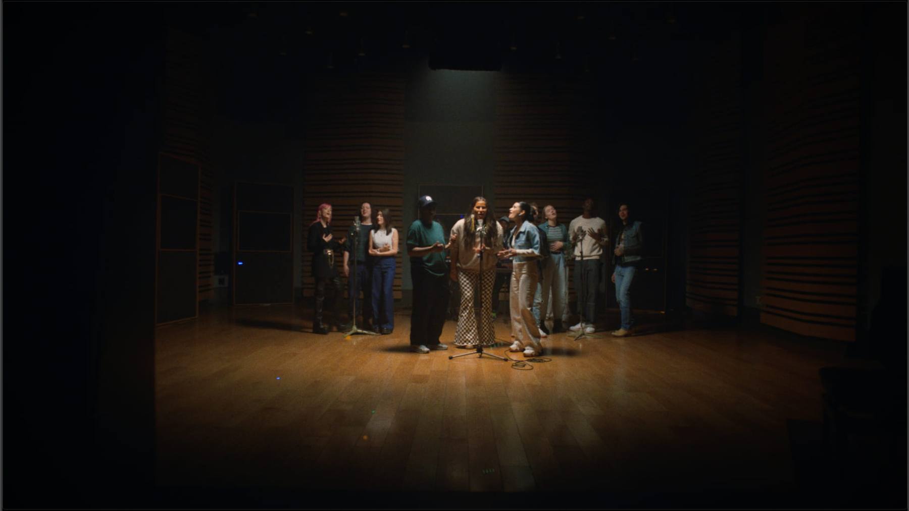 An ensemble recording session under a single spotlight