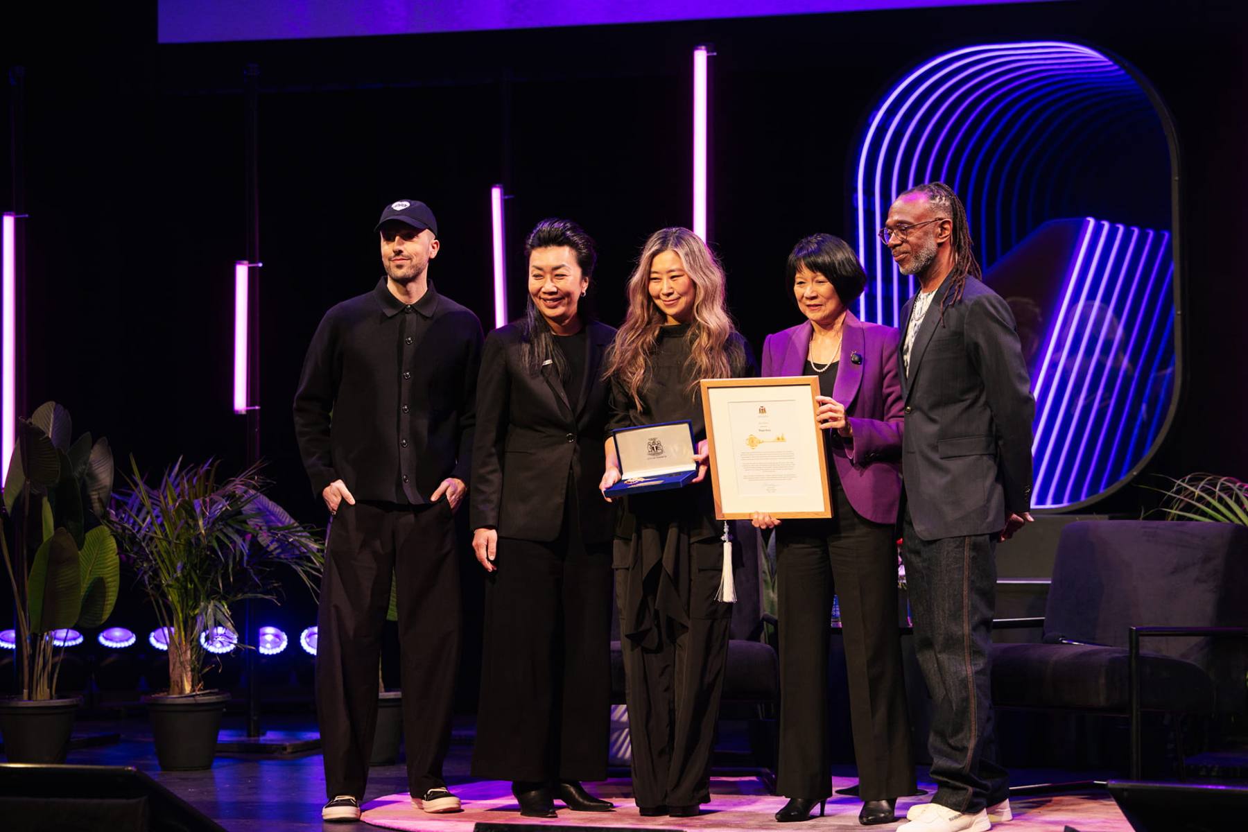 An award presentation on a lit stage