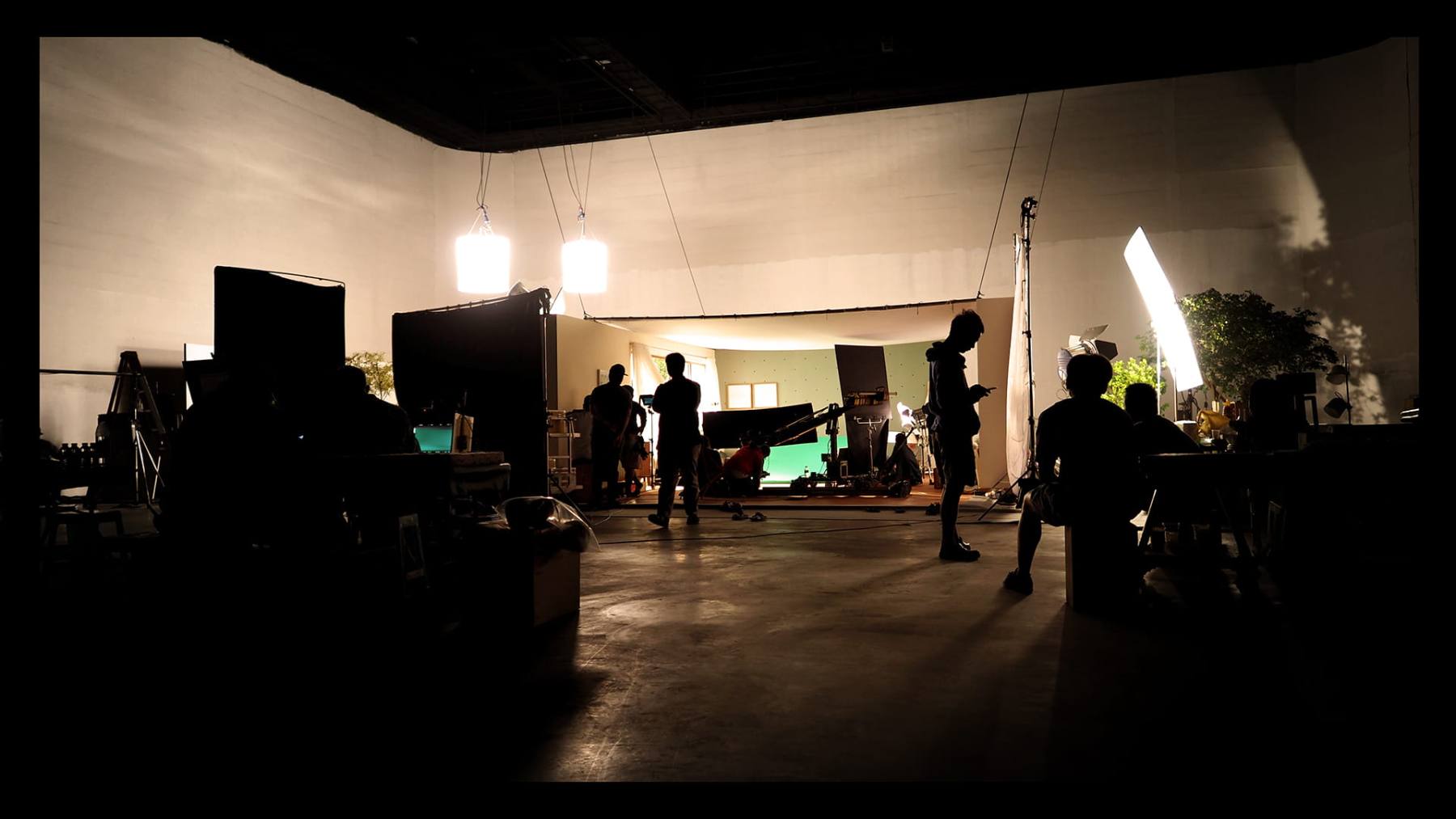 Crew silhouetted inside a film production studio